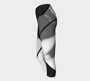 Whites, greys and blacks in a bold color blocking pattern on these compression capri leggings.