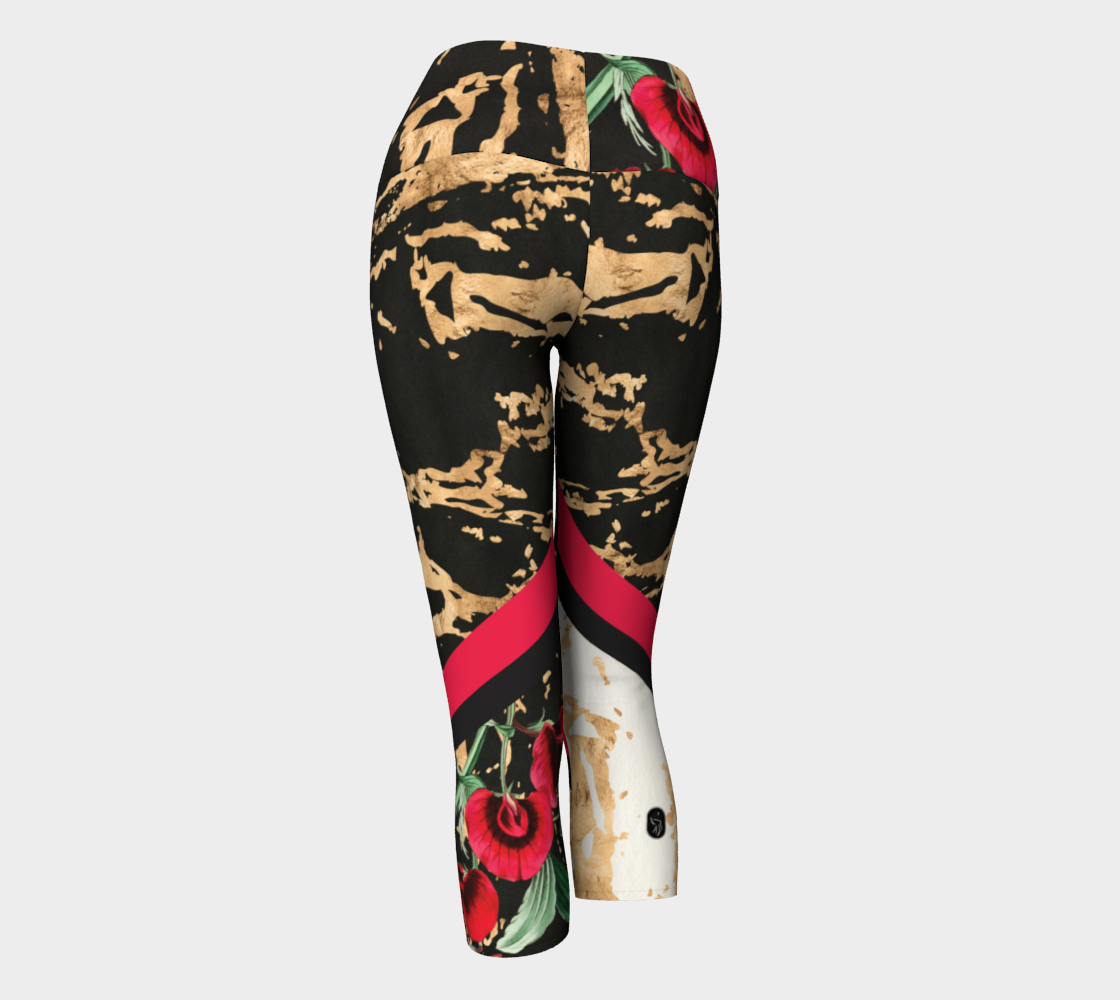 Red botanicals splash onto a gold splattered background on these capri length leggings