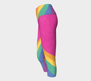 Rainbow color blocking against a bright pink backdrop on capri length leggings