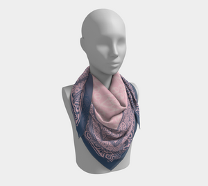 This silk scarf features contrasting patterns in pink and navy with a beautiful floral in the center.