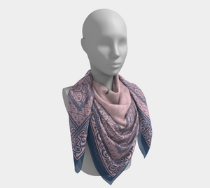 This silk scarf features contrasting patterns in pink and navy with a beautiful floral in the center.