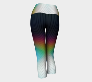 Geometrical patterns transform into rainbow colors, to create a stunning look on these capri length leggings