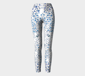 Compression leggings adorned with tiny blue florals and hummingbirds.