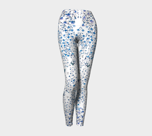 Compression leggings adorned with tiny blue florals and hummingbirds.