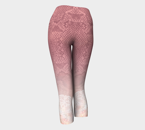 Pink hued snakeskin mingle with delicate lace on these capri length compression leggings
