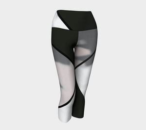 Whites, greys and blacks in a bold color blocking pattern on these compression capri leggings.