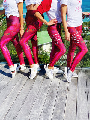 Billows of red clouds set amidst pink snakeskin, dusted with snakes and red butterflies on these compression leggings