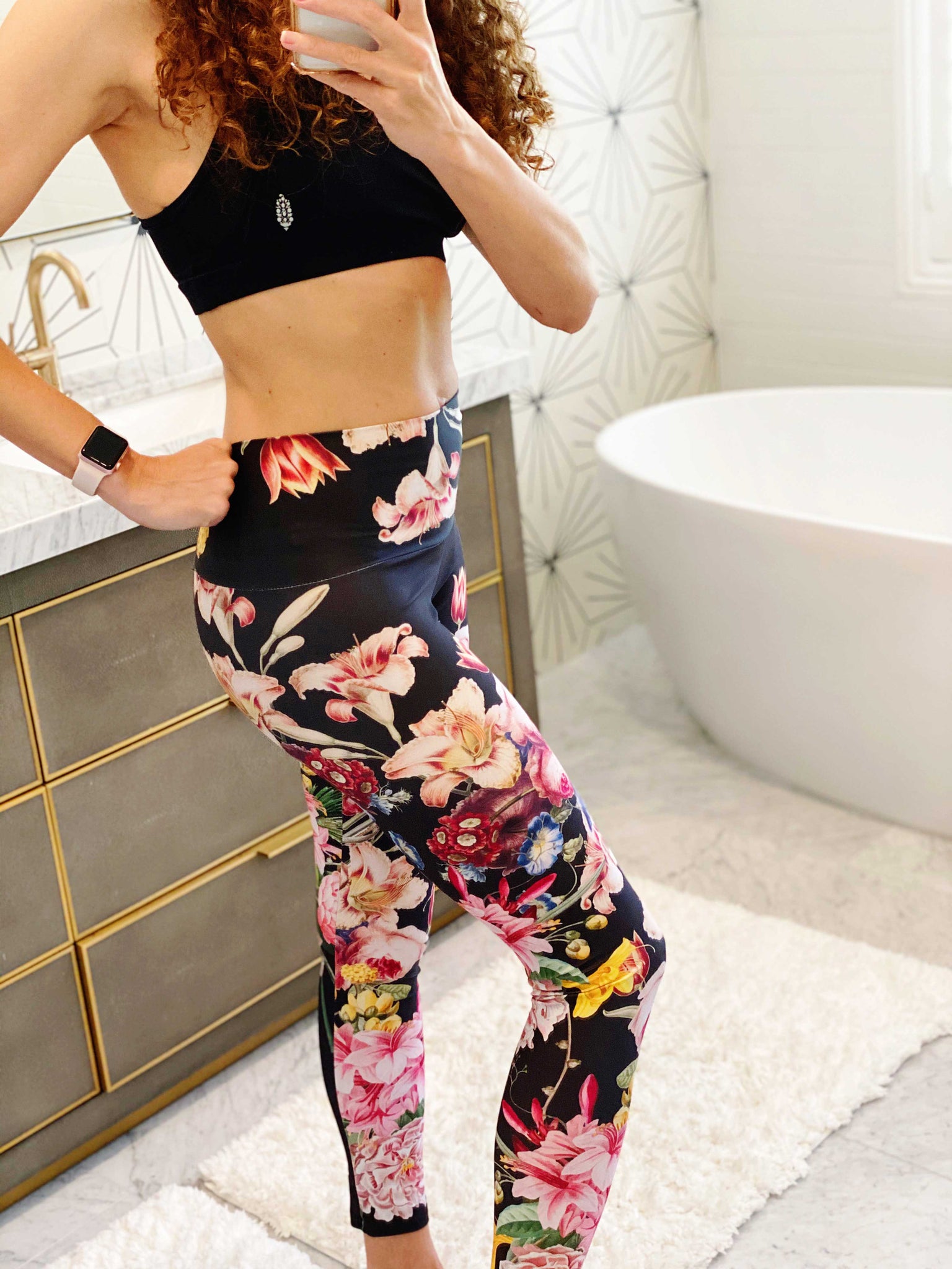 A deep black midnight acts as the background for brilliant beautiful florals on these compression leggings