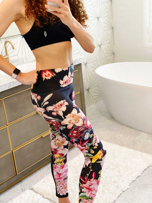 A deep black midnight acts as the background for brilliant beautiful florals on these compression leggings