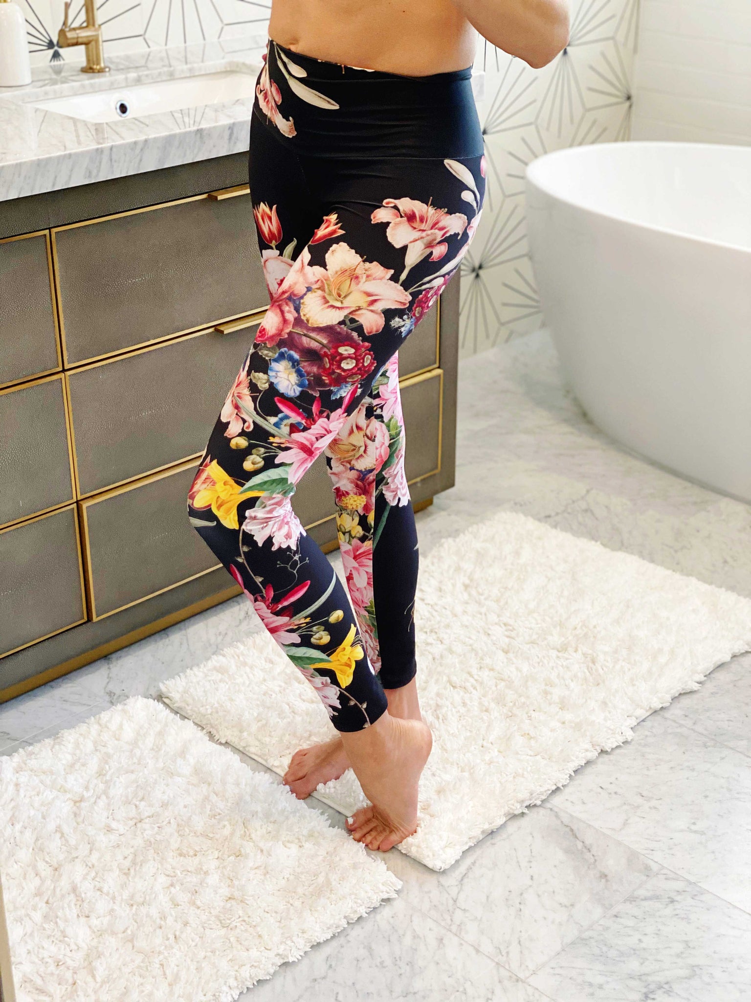 A deep black midnight acts as the background for brilliant beautiful florals on these compression leggings