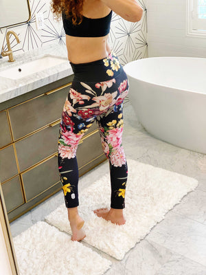 A deep black midnight acts as the background for brilliant beautiful florals on these compression leggings