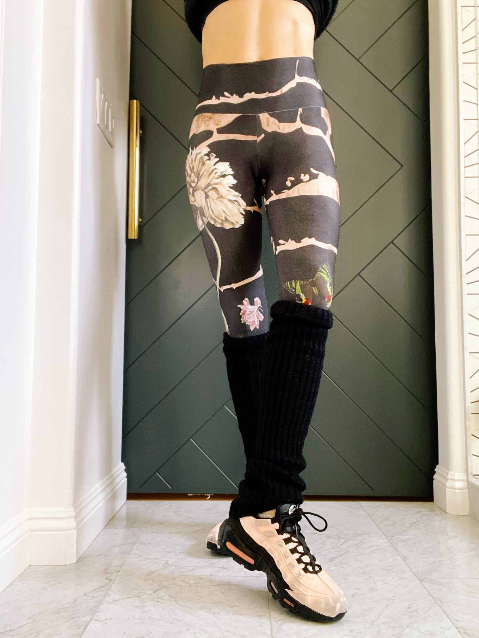 Black knee high leg warmers with a Signature Sweat Goddess tag on one leg