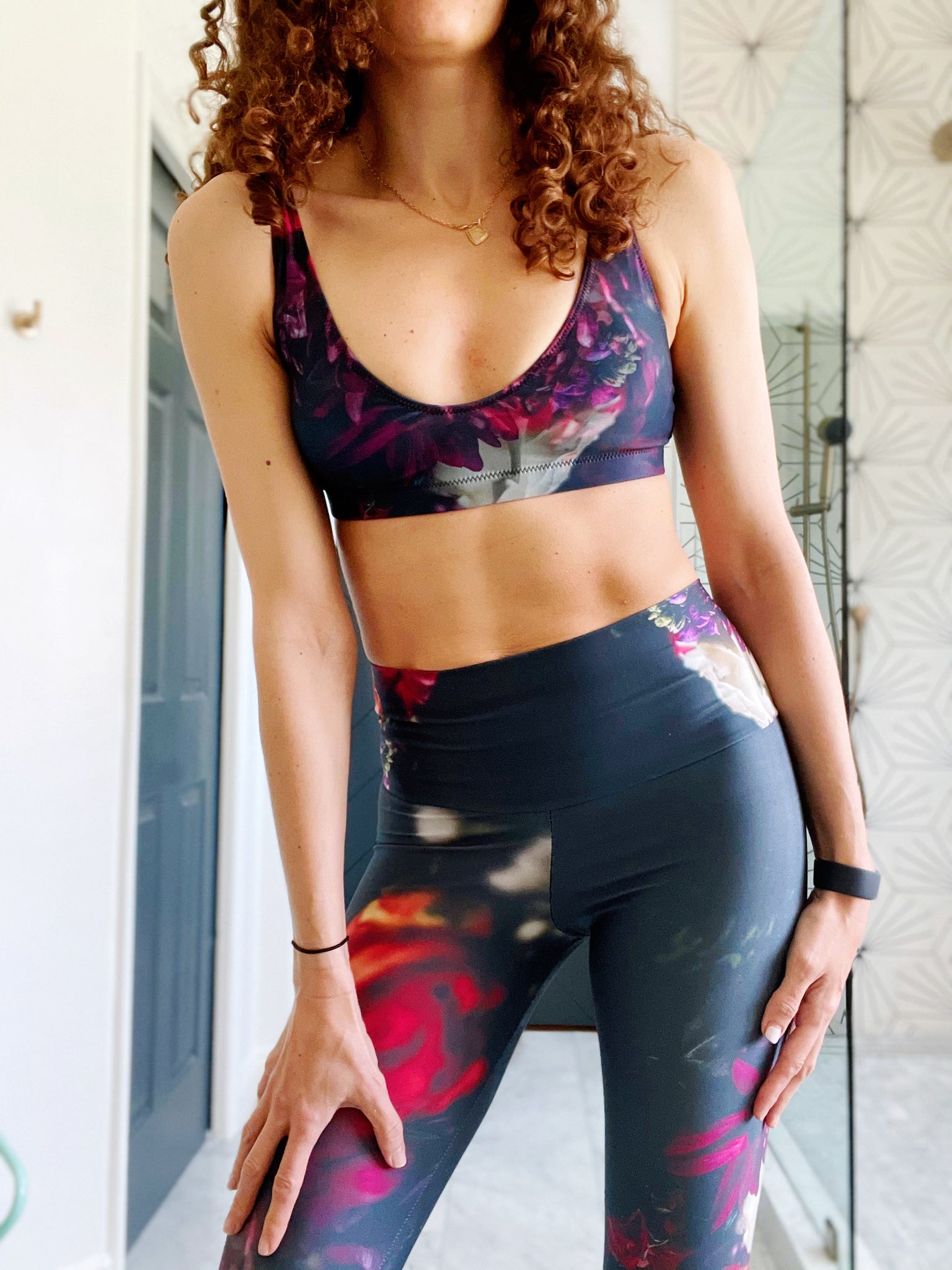 Sports bralette with removable pads made from recycled materials featuring dark moody florals