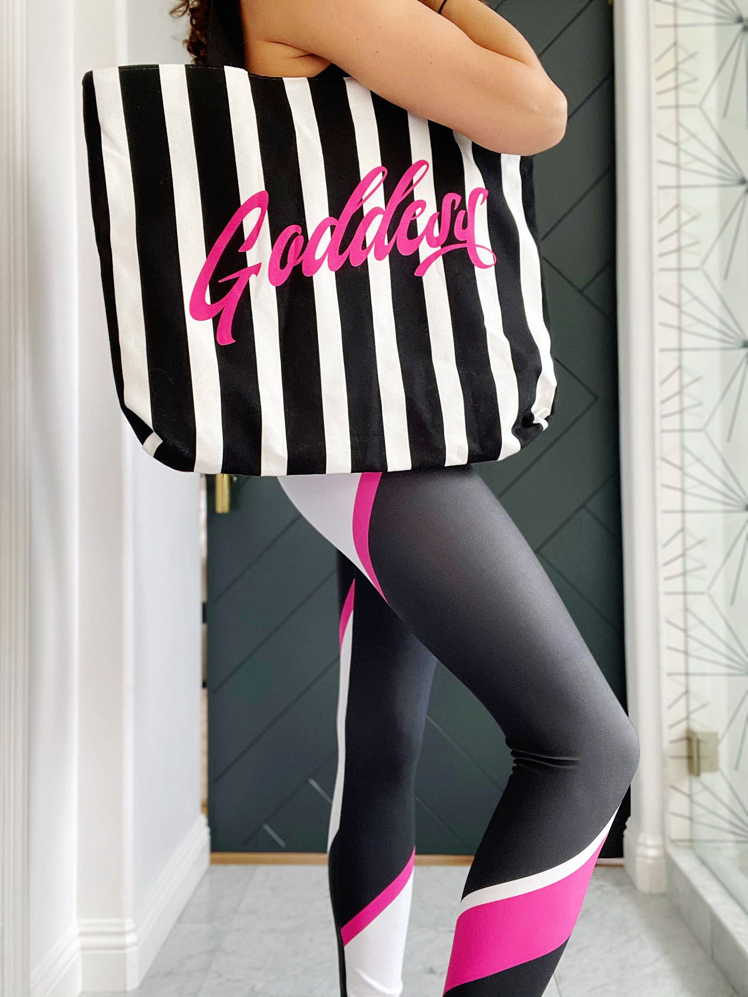 Black and pink striped luxe tote bag with the word "Goddess" featured. Fully lined with 2 interior pockets and a magnetic closure.
