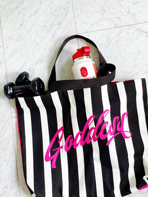Black and pink striped luxe tote bag with the word "Goddess" featured. Fully lined with 2 interior pockets and a magnetic closure.