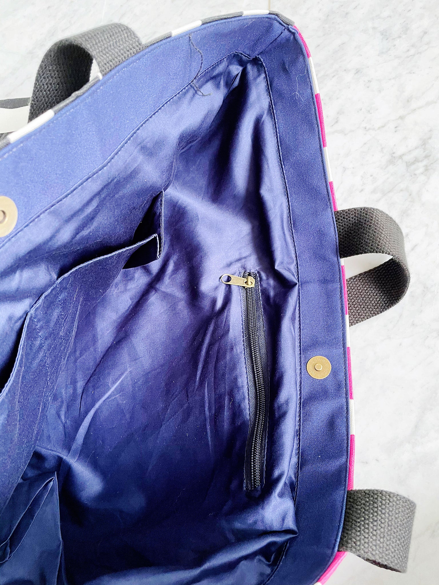 Our signature stripes luxe tote shown in a bold pink and blue with the word "Goddess" on the bag, features 2 interior pockets and a navy blue lining.