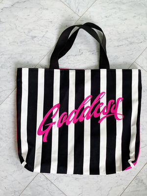 Black and pink striped luxe tote bag with the word "Goddess" featured. Fully lined with 2 interior pockets and a magnetic closure.