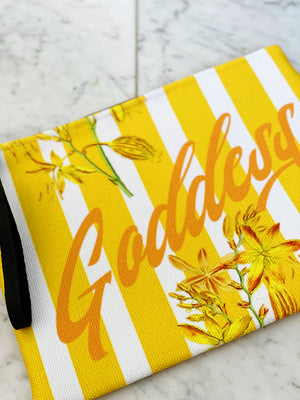 Luxe canvas pouch, fully lined with vegan leather details, featuring our yellow stripes and florals print with the word "Goddess" on the front.