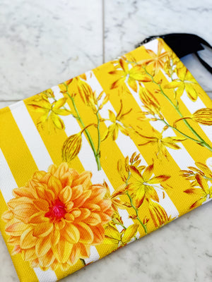 Luxe canvas pouch, fully lined with vegan leather details, featuring our yellow stripes and florals print with the word "Goddess" on the front.