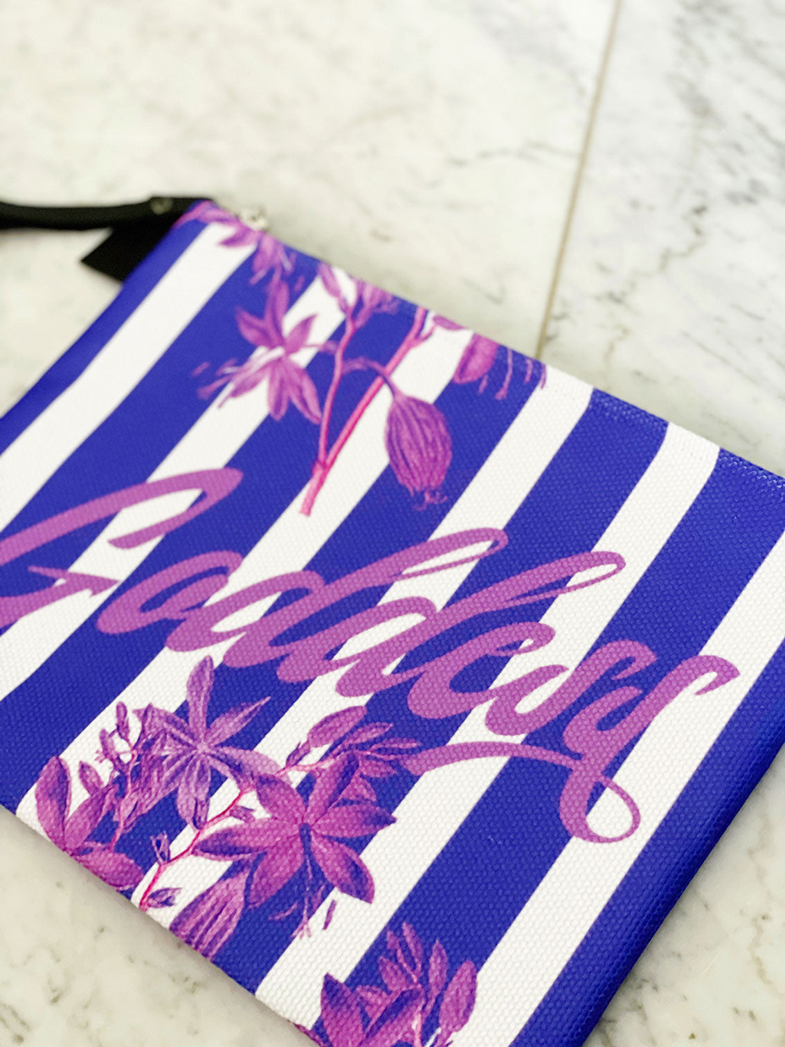 purple stripes and florals adorn this luxe zipper pouch