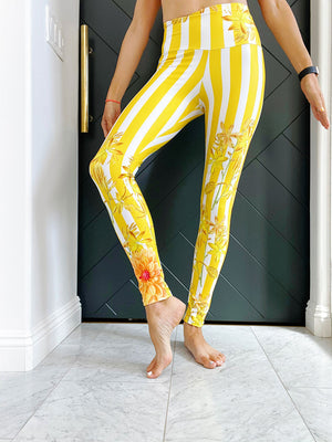 Bold yellow stripes and florals adorn these high waisted compression leggings