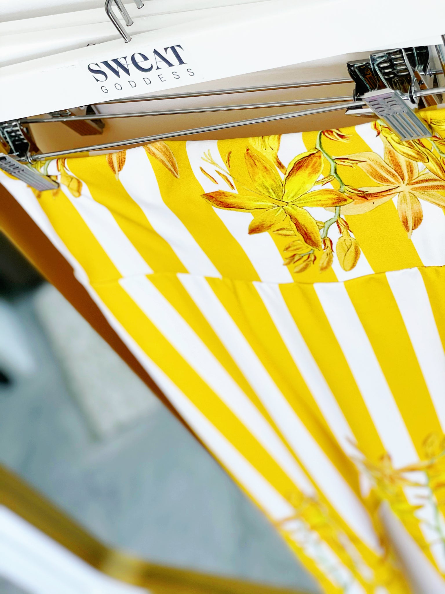 Bold yellow stripes and florals adorn these high waisted compression leggings