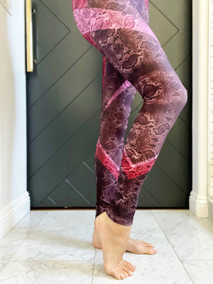 High waisted compression leggings in a red and pink snakeskin print