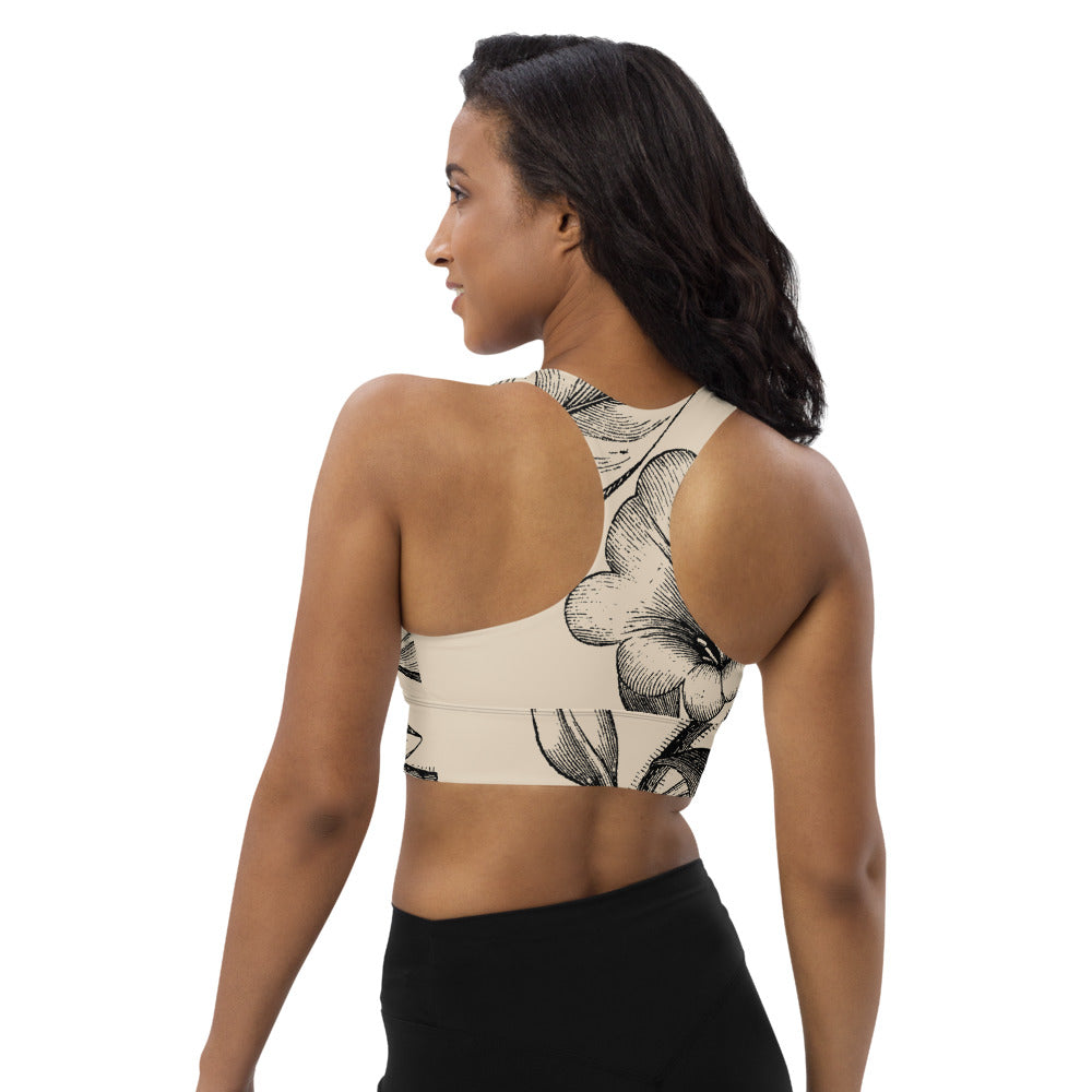 Signature sports bra featuring vintage botanicals against an ivory background.