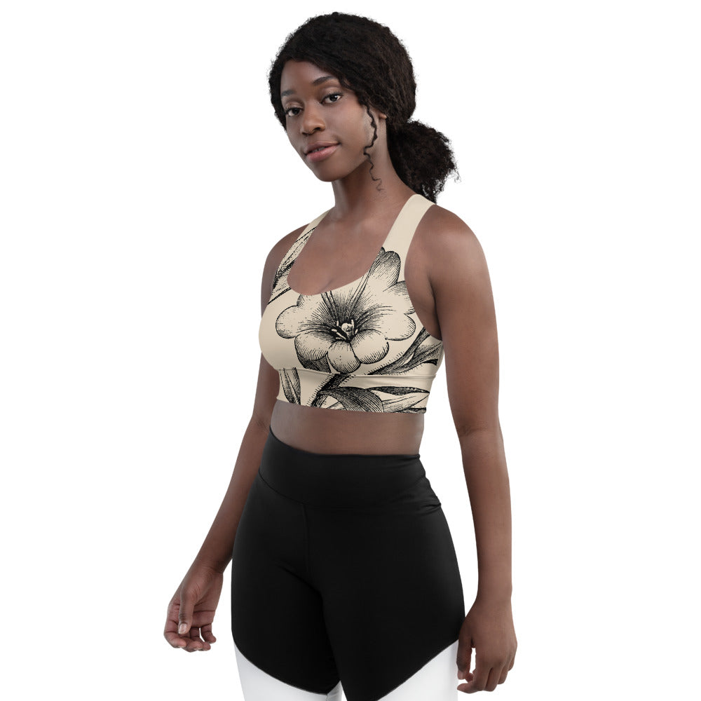 Signature sports bra featuring vintage botanicals against an ivory background.