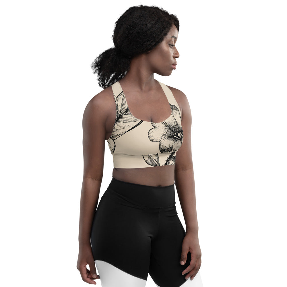 Signature sports bra featuring vintage botanicals against an ivory background.