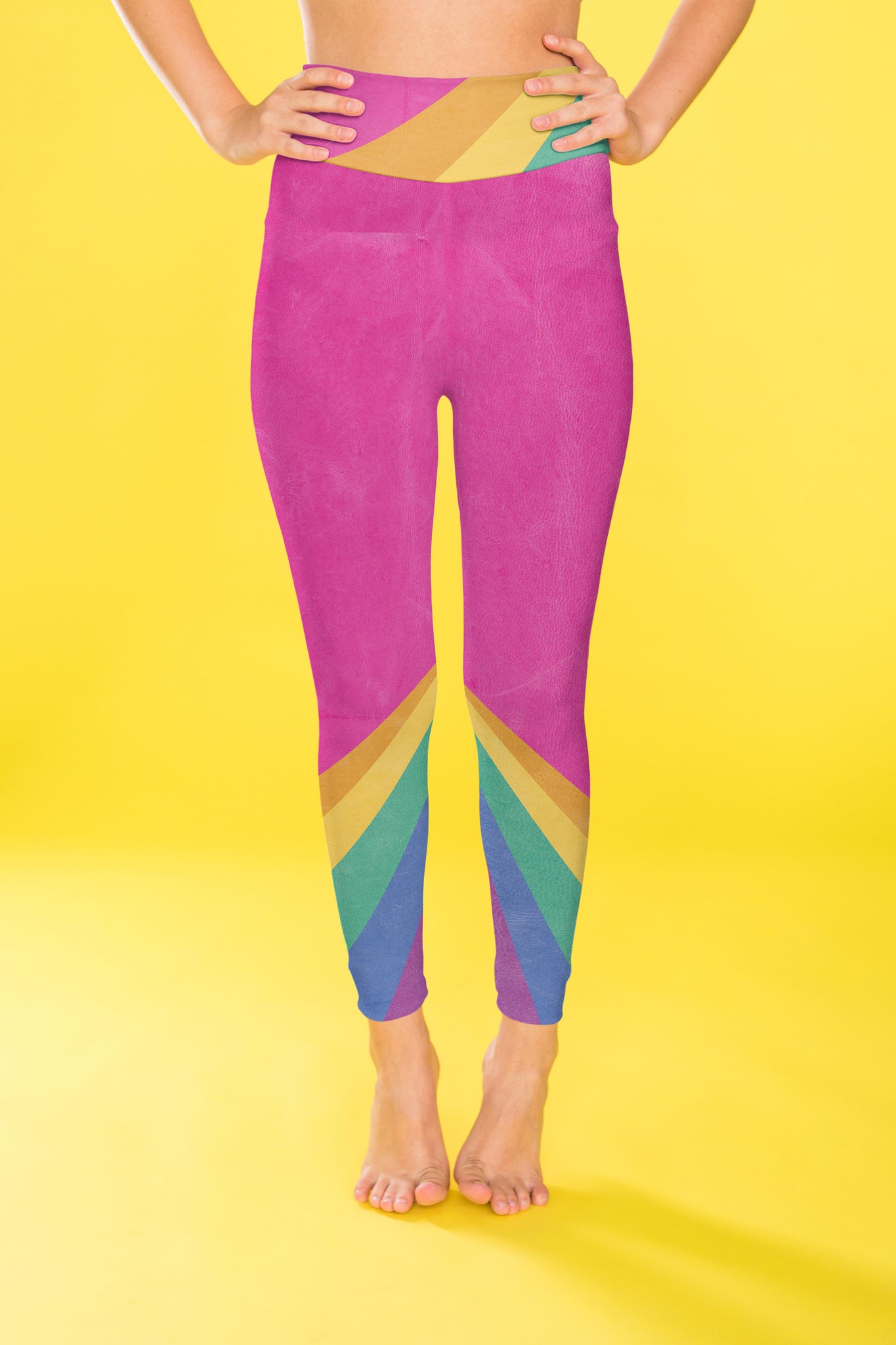 Rainbow color blocking against a bright pink backdrop on these compression leggings