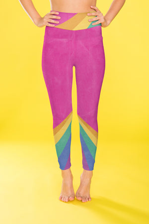 Rainbow color blocking against a bright pink backdrop on these compression leggings