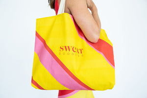 This oversize cotton canvas tote features our signature color blocking in yellow, red and pink adorned with our Sweat Goddess logo