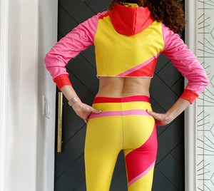 Bold yellow red and pink color blocking adorn this crop hoodie