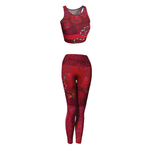 Billows of red clouds set amidst pink snakeskin, dusted with snakes and red butterflies on this athletic top