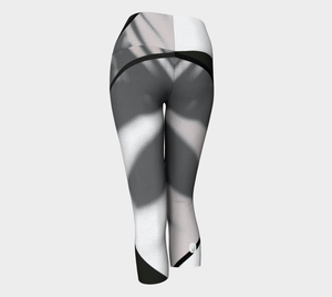 Whites, greys and blacks in a bold color blocking pattern on these compression capri leggings.