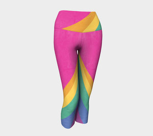 Rainbow color blocking against a bright pink backdrop on capri length leggings