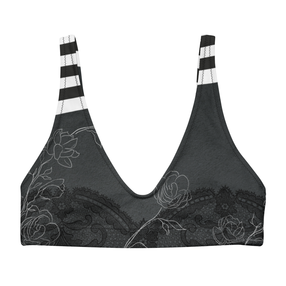 A dark night with delicate floral drawings and black and white bold stripe details adorn this bikini/sports bra.