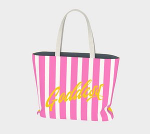 Our signature stripes luxe tote shown in a bold pink and yellow with the word "Goddess" on the bag, features 2 interior pockets and a navy blue lining.