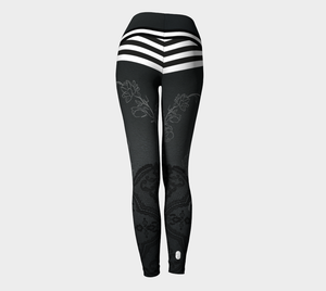 A dark background with delicate floral drawings and faux booty shorts in bold stripes on these compression leggings