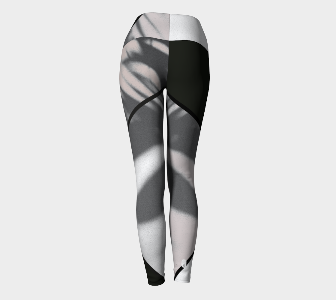 A bold black and white color blocking print adorn these high-waisted compression leggings